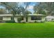 Beautiful backyard with lush green lawn and access from home at 1606 Laughton Pl, Sun City Center, FL 33573