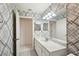 Modern bathroom with geometric patterned wallpaper and new vanity at 1606 Laughton Pl, Sun City Center, FL 33573