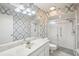 Bathroom features a marble vanity, a toilet, and a glass-enclosed shower at 1606 Laughton Pl, Sun City Center, FL 33573