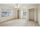 Well-lit bedroom with two closets and a ceiling fan at 1606 Laughton Pl, Sun City Center, FL 33573