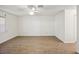 Spacious bedroom with ceiling fan and wood-look floors offers a bright, airy feel at 1606 Laughton Pl, Sun City Center, FL 33573