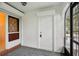 Front entry with white door and terracotta tile flooring at 1606 Laughton Pl, Sun City Center, FL 33573
