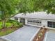 An exterior view of a single Gathering home with a two-car garage and landscaping at 1606 Laughton Pl, Sun City Center, FL 33573