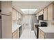 Well-lit kitchen featuring sleek appliances, light wood cabinetry, and a skylight at 1606 Laughton Pl, Sun City Center, FL 33573