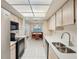 Bright kitchen with modern appliances, white countertops, and adjacent dining area at 1606 Laughton Pl, Sun City Center, FL 33573