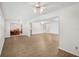 Open-concept living area with hardwood floors, white walls, and natural light at 1606 Laughton Pl, Sun City Center, FL 33573