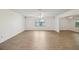 Open concept living room with wood floors and abundant light at 1606 Laughton Pl, Sun City Center, FL 33573