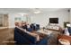 Staged living room with modern furniture, wood floors and abundant light at 1606 Laughton Pl, Sun City Center, FL 33573