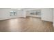 Large living room with wood floors, large windows, and neutral walls at 1606 Laughton Pl, Sun City Center, FL 33573