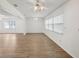 Spacious living room with hardwood floors, white walls, and ceiling fans at 1606 Laughton Pl, Sun City Center, FL 33573