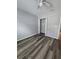 Bedroom with grey walls, wood-look flooring, and a spacious closet at 710 E Alabama St, Plant City, FL 33563