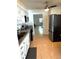 Galley kitchen with updated stainless steel appliances, light countertops, and a ceiling fan at 11200 102Nd Ave # 60, Seminole, FL 33778