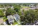 Birds eye view of a modern home in a tree-filled neighborhood with a school in the background on a sunny day at 2909 W Spruce St, Tampa, FL 33607