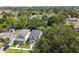 An aerial of a modern two-story home nestled in a green, tree-filled neighborhood on a sunny day at 2909 W Spruce St, Tampa, FL 33607