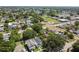 An aerial shot overlooking a lush neighborhood with a modern two-story home and school nearby at 2909 W Spruce St, Tampa, FL 33607