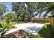 Spacious backyard featuring a newly poured concrete pad and lush landscaping at 2909 W Spruce St, Tampa, FL 33607