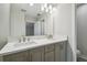 Bright bathroom with double sink vanity, white countertop, and neutral gray cabinets at 2909 W Spruce St, Tampa, FL 33607