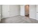 Neutral bedroom with plush carpeting, white trim, and two doors at 2909 W Spruce St, Tampa, FL 33607