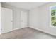 Bright bedroom with neutral carpet, a window, and white trim at 2909 W Spruce St, Tampa, FL 33607