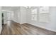 Contemporary dining area featuring hardwood floors, white walls, and large windows for ample natural light at 2909 W Spruce St, Tampa, FL 33607