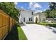 A bright, modern two-story home with a new driveway, lush landscaping and a privacy fence at 2909 W Spruce St, Tampa, FL 33607