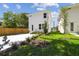 Beautiful two-story home boasts a modern design, green yard, a long driveway and privacy fence at 2909 W Spruce St, Tampa, FL 33607