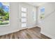 Bright entryway featuring wood-look floors, white walls, and stylish front door at 2909 W Spruce St, Tampa, FL 33607
