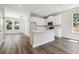 Well-lit kitchen featuring island, white cabinetry, and stainless steel microwave at 2909 W Spruce St, Tampa, FL 33607