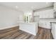 Modern kitchen boasts white cabinets, an island, and stainless steel appliances at 2909 W Spruce St, Tampa, FL 33607