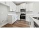 Efficient kitchen design features stainless steel appliances and white cabinetry at 2909 W Spruce St, Tampa, FL 33607