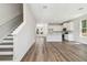 Open-concept living room featuring hardwood floors and abundant natural light at 2909 W Spruce St, Tampa, FL 33607