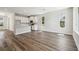 Open-concept living room with a modern kitchen, white cabinets, and wood floors at 2909 W Spruce St, Tampa, FL 33607