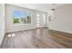 Bright, modern living room with large windows and wood-look floors at 2909 W Spruce St, Tampa, FL 33607
