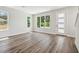 Spacious living room featuring wood floors, white trim, and lots of natural light at 2909 W Spruce St, Tampa, FL 33607