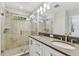 Stylish bathroom with a glass-enclosed shower, dual sinks, and contemporary lighting at 2911 W Spruce St, Tampa, FL 33607