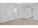 Spacious bedroom with plush carpet, tray ceiling, and multiple doors leading to other rooms at 2911 W Spruce St, Tampa, FL 33607