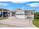 White mobile home with covered porch at 4845 Elwana Way, Zephyrhills, FL 33541