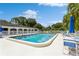 Inviting community pool with lounge chairs and umbrellas at 11200 102Nd Ave # 60, Seminole, FL 33778