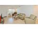 Living room features light colored leather furniture and wood flooring at 11200 102Nd Ave # 60, Seminole, FL 33778