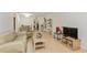 Living room with light-colored leather furniture, wood floors, and display cases at 11200 102Nd Ave # 60, Seminole, FL 33778