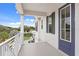 Open-air balcony with white railings, covered porch, and views of the green neighborhood at 4017 W Fig St, Tampa, FL 33609