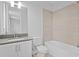 Clean bathroom featuring single sink vanity, tile floors and shower with tub at 4017 W Fig St, Tampa, FL 33609