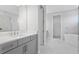 Luxurious bathroom with marble flooring, double vanity, walk-in shower, and bathtub at 4017 W Fig St, Tampa, FL 33609