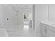 Marble tile bathroom with walk-in shower, tub, and vanity with double sinks at 4017 W Fig St, Tampa, FL 33609