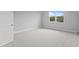 Bright bedroom with neutral carpet, light walls, and a window offering exterior views at 4017 W Fig St, Tampa, FL 33609