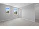 Spacious bedroom with carpet, two windows, ensuite bathroom, and walk-in closet at 4017 W Fig St, Tampa, FL 33609