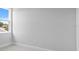 Bright bedroom with neutral carpet, light walls, and a window at 4017 W Fig St, Tampa, FL 33609