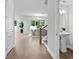 Bright hallway with a staircase, leading to a dining area with a decorative light fixture at 4017 W Fig St, Tampa, FL 33609