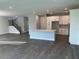 Open-concept kitchen with island, white cabinets, and hardwood flooring at 4017 W Fig St, Tampa, FL 33609