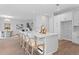 Modern kitchen island with bar stool seating overlooking the dining area and staircase at 4017 W Fig St, Tampa, FL 33609
